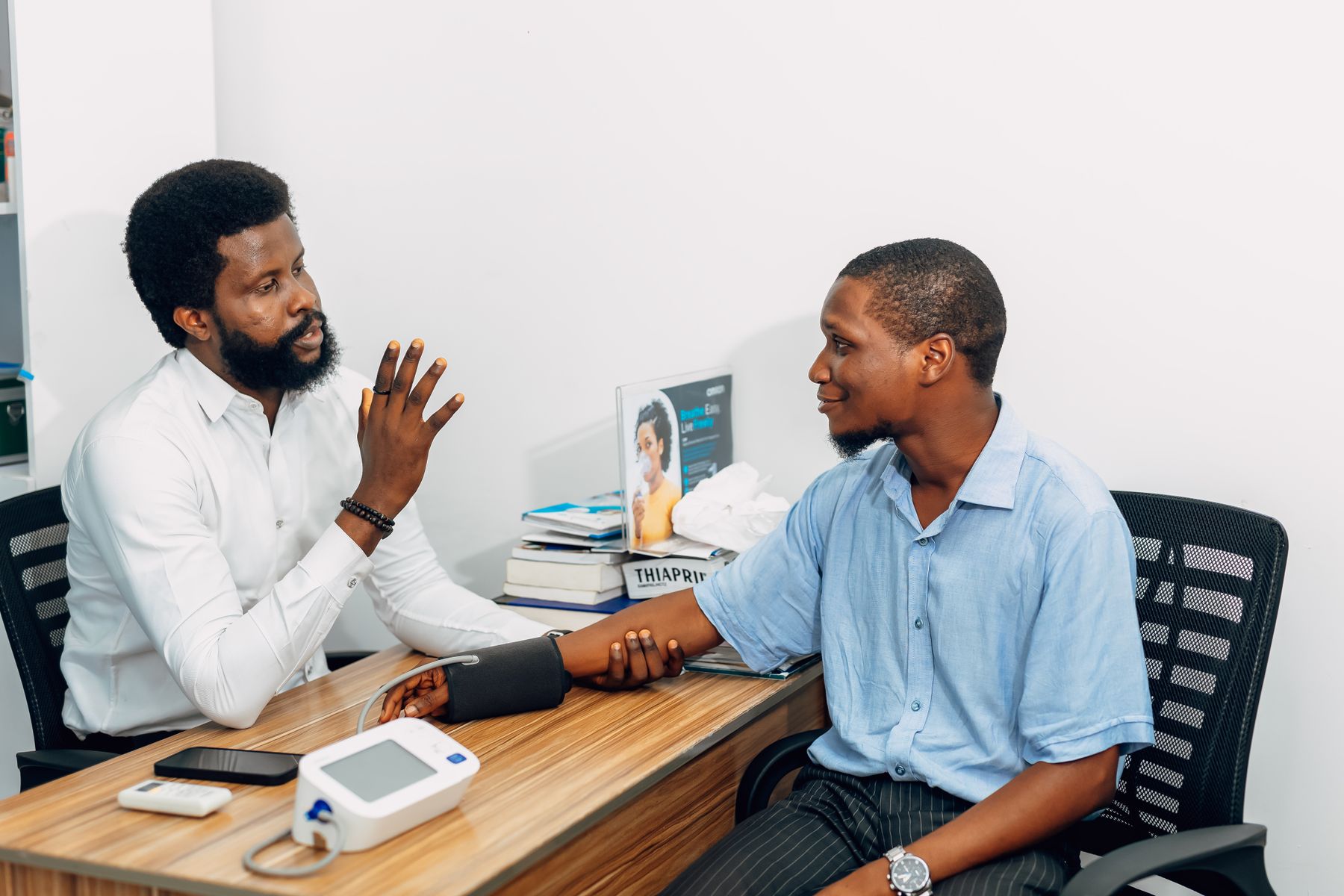 A clinician talking with a patient during a consultation